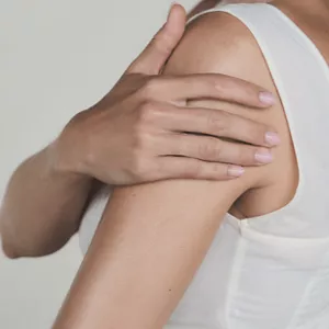 Person applying Cellular Performance Body Firming Emulsion on their airm with their hand